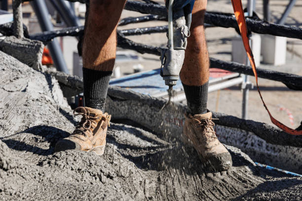 Construction Worker Spraying Concrete On Construction Site